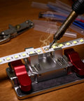 All In One Soldering Station And Welding Table Clamps With Ceramic Tips Aluminum Third Hand Tool For PCB Wire And LED Strip Electronics Repair For Precise PCB Assembly And Wire Work, showing soldering iron on LED strip