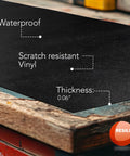 Close-up of heavy duty work bench mat showcasing waterproof scratch-resistant vinyl and 0.06 inch thickness on wooden surface.