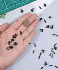 Hand holding components from 20 Sets Metal Zipper Repair Kit With Latch Sliders Retainers And Insertion Pins for garment repair.