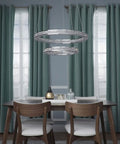 Hella Sharp Six Light Ceiling Pendant With Glossy Polished Chrome Trim And Classic Beveled Crystal Glass Shades, suspended over a dining table.