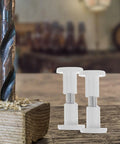 50 White Wood Panel Fasteners And Connector Bolts Kit For Cabinet And Tabletop Assembly, shown with drill and wood shavings