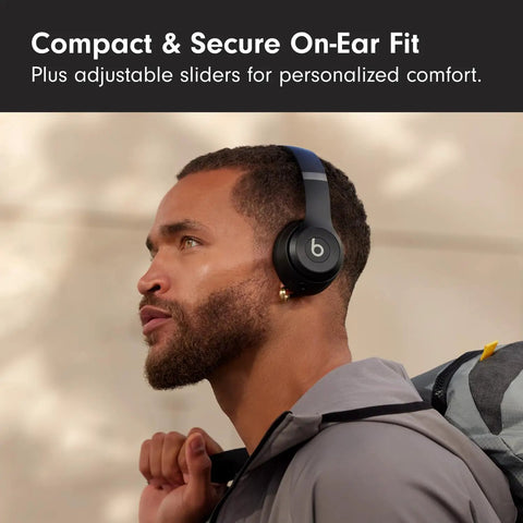 Solo 4 Wireless Bluetooth On-Ear Headphones Serving Serious Heat And 50-Hour Battery Life For Your Daily Ride Built With Ultra Lightweight Flex-Grip Cushions And Immersive Spatial Audio Technology In Matte Black worn by a man with adjustable sliders for fit.