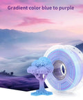 PetG Filament 1.75mm Gradient Translucent Blue to Purple spool and 3D printed tree art piece.