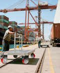 Heavy Duty Industrial Caster Wheels With 5000 Pound Capacity Polyurethane Treads And Cast Iron Cores in use on warehouse cart.