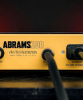Back panel view of Abrams100 100W Guitar Amp Head with Class D Power, yellow case, power inputs, and connections visible