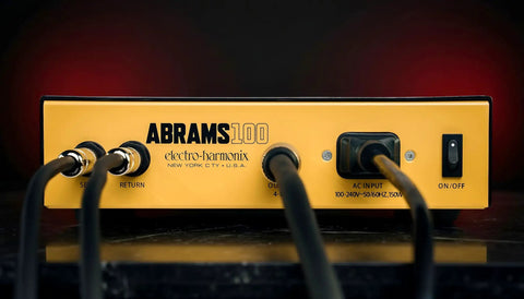 Back panel view of Abrams100 100W Guitar Amp Head with Class D Power, yellow case, power inputs, and connections visible