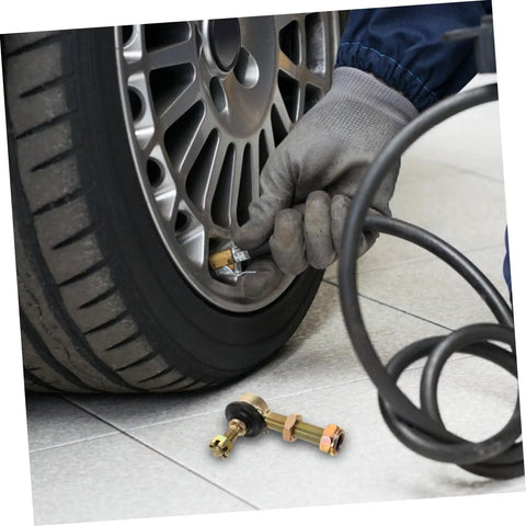 Mechanic checking tire pressure with Beefed Up Off Road Ball Joint Kit For ATVs With Adjustable Suspension on floor nearby.