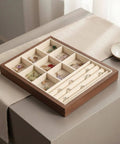 Slick Walnut Wood Jewelry Display Tray With Dope 24 Compartments For Rings Earrings Necklaces, neatly organized on a table.