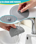 Person using Six Inch Silicone Tub Stopper Five Pack Flat Suction Drain Plug That Locks Smooth As Silk For Bathtub Or Kitchen Sink Foul Odor Blocked Heavy Duty Rinse Ready Cover White Grey Black in sink.