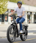 Adult riding High Torque Electric Fat Bike For Adults with 1800W peak power and 864Wh removable battery on city street.