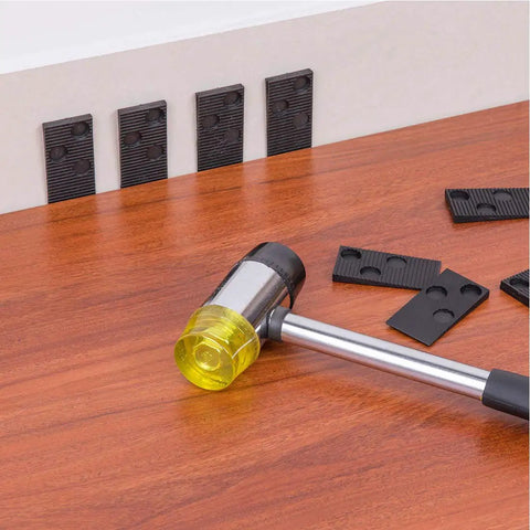 Pro Grade Laminate Flooring Installation Kit with spacers and heavy duty mallet on wooden floor