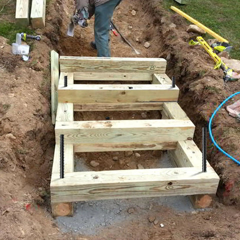 Wooden frame secured with Twenty Pack Of 24 Inch Straight Rebar Stakes With One Half Inch Diameter Steel For Heavy Duty Ground Anchors