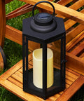 Outdoor Solar Powered Lantern With Flameless Candle 18 Inch Black Metal And Glass Waterproof Hanging Tapered Candle Lamp on wooden table