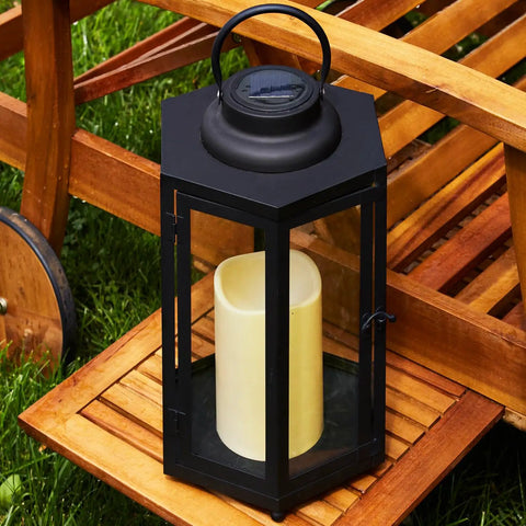 Outdoor Solar Powered Lantern With Flameless Candle 18 Inch Black Metal And Glass Waterproof Hanging Tapered Candle Lamp on wooden table
