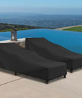 Two black chaise lounge covers by a pool, showing waterproof outdoor protectors with windproof straps on loungers.