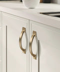 Brushed brass cabinet pulls on white kitchen cabinets, part of the 10 Pack Brushed Brass Cabinet Pulls 3 Inch Hole Center 4.4 Inch Overall Length.