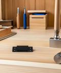 Heavy Duty Hidden Door Hinge 5 Inch Black Square Pivot for Interior Bookcases and Folding Boxes on wooden table