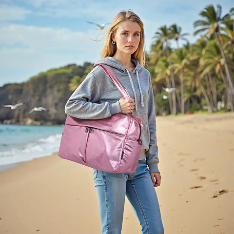 Woman with 45L Waterproof Duffle Bag For Women Lightweight Carry On Weekender With Separate Shoe Pocket And Multiple Internal Pockets Durable Travel Tote For Gym And Weekend Getaways Pink on a beach
