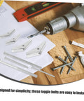 32 Piece Toggle Bolt And Wing Nut Kit For Heavy Duty Drywall Anchors No Fuss Easy Install Fasteners For Hanging Mirrors, Shelves And Furniture, Versatile Iron Construction DIY Kit For Quick, Solid Mounts. Drill bit with toggle bolts, screws, and wall anchors on wood surface