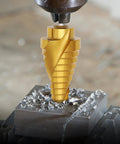 Close-up of a titanium-coated step drill bit in use on metal, part of Five Piece Titanium Coated HSS Step Drill Bit Set With Fifty Hole Sizes