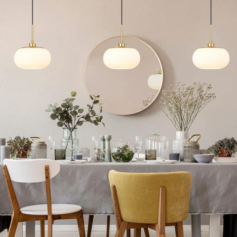 Dining room with two Single Opal Glass Pendant Lights With Antique Brass Finish for a Cozy Modern Vibe over white table