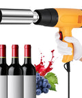 PVC Capsule Heat Shrinker For Wine Bottles 50mm Sealing Machine with handheld design, shown with capped wine bottles and grapes.