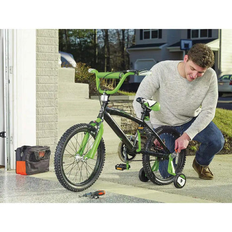 Man using 12V Max Drill And Home Tool Kit 60 Piece Set with Compact Lithium Ion Drill Driver to fix bicycle in driveway.