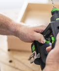 Person using Compact Cordless Drill Driver CXS 18 HPC 18V with 4.0 Ah Battery in workshop setting