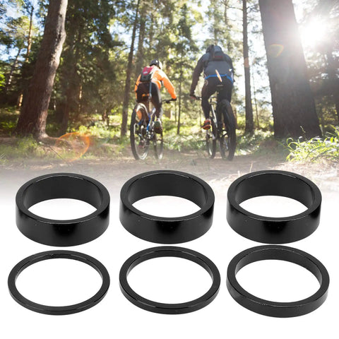 Six Piece Aluminum Bike Headset Spacer Set With 2mm 3mm 5mm And 10mm Heights For Twenty Eight Point Six Millimeter Forks One And One Eighth Inch Stems Black displayed on forest trail background