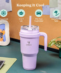 Chill Out With This Wicked 40 Oz Stainless Steel Tumbler Features A Sturdy Handle And Elite Dual Wall Insulation on a desk.