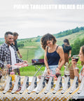 Heavy Duty Beefy Stainless Steel Tablecloth Clips 10 Pack in use at outdoor picnic; people enjoying a festive meal.