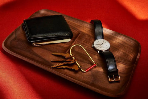 Wilson Brass Keyring With 2 Inch Carabiner Clip on tray with watch, wallet, and keys