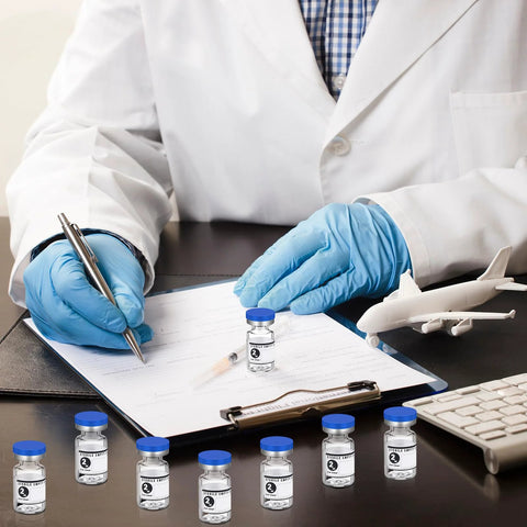 Front view of several Threlaco 2ml sealed sterile glass vials with blue caps and white labels on a lab desk