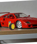 Electric Motor And Plastic Tire Wheel Set For RC Cars And Trucks next to a red model car on a wooden shelf