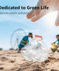 Hand reaching for a crumpled plastic bottle on the beach, promoting green life and reducing pollution.