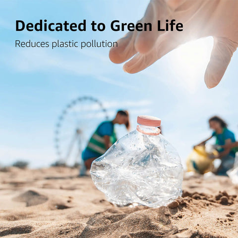 Hand reaching for a crumpled plastic bottle on the beach, promoting green life and reducing pollution.