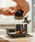 Person using Picopresso Portable Espresso Maker Bundle With Protective Case For Pro Level Coffee On The Go Ultra Fine Grind Compatible Manual Travel Espresso System Delivers Creamy Shots And Dense Flavor to pour espresso