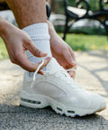 Upgrade Your Daily Drip With Top Tier Metal Alloy Shoe Lace Tips Built To Outlast Worn Aglets Quick Fully Adjustable Cord Ends Fit Any Pair Of Modern Trainers Perfectly on white sneaker with laces being tied.