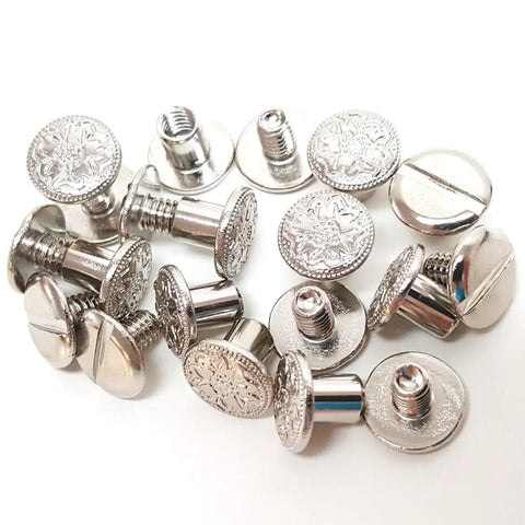 Heavy Duty Quarter Inch Chicago Screws 10 Pack Nickel Plated Floral Engraved Turnbuckle Fasteners, close-up of screws for leather gear.