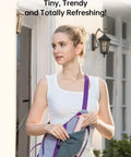 Woman inserting 3 In 1 Pocket Handheld Mini Fan With Built In Power Bank And Flashlight USB Rechargeable into a sling bag