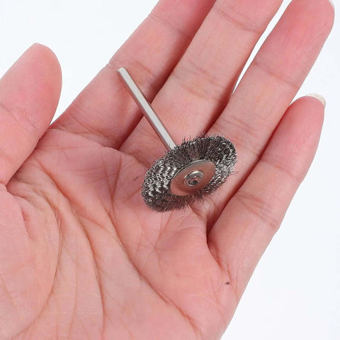 Close-up of a stainless steel wire brush from the 15 Piece Stainless Steel Wire Brush Set For Drill And Grinder Heavy Duty Cleaning Rust Removal Polishing And Metal Finishing For Industrial Automotive Home Use Compatible With Electric Grinders And Handheld Polishers, held in a hand for scale.