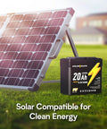 12V 20Ah LiFePO4 Battery Two Pack With Built In BMS IP67 Waterproof next to solar panel on grass, focus on battery and panel.