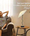 Harp Folding Lamp Set Two Pieces, Modern Umbrella Pleated Desk Lamp With White Shade on table next to relaxed woman