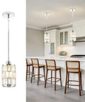 etiruety Adjustable Modern Crystal Chrome Pendant Lights Kitchen Island in a kitchen with a modern design and wood seating.