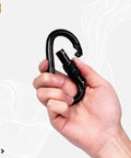 Hand holding Beefy Locking Screwgate Carabiner 25kN Heavy Duty For Climbing Rappelling CE Certified Carbon Steel Midnight Black