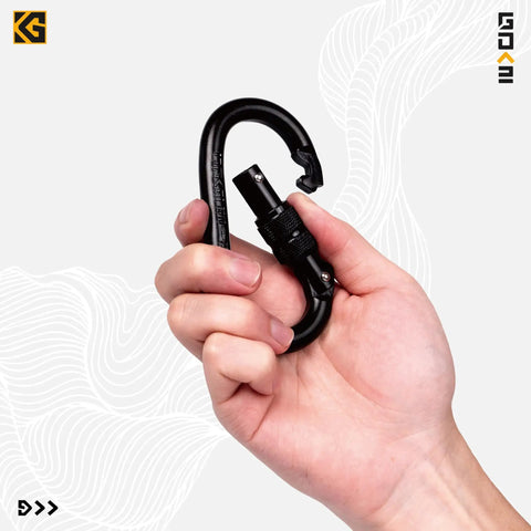Hand holding Beefy Locking Screwgate Carabiner 25kN Heavy Duty For Climbing Rappelling CE Certified Carbon Steel Midnight Black