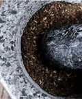 Top view of Mortar And Pestle Set Granite Spice Grinder 2 Cup Capacity with ground spices inside, showcasing durable stone tool.