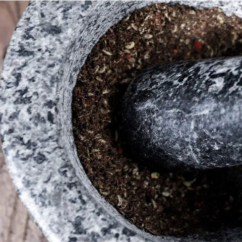 Top view of Mortar And Pestle Set Granite Spice Grinder 2 Cup Capacity with ground spices inside, showcasing durable stone tool.