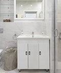 Modern bathroom with white cabinet, marble tiles, and glass shower enclosure