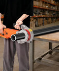 User operating the Built Tough Portable Pipe Threader Driven By 2300 Watt Copper Motor and Six Grip Tight Dies on a black pipe.